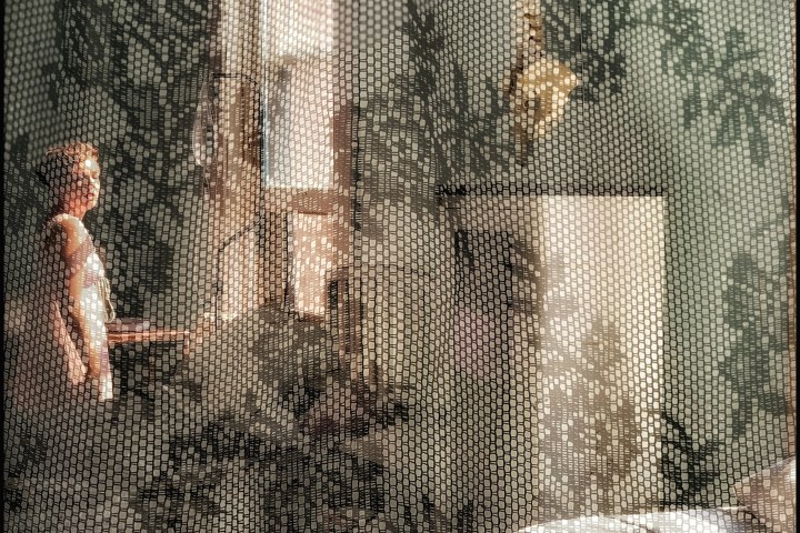 a person standing in front of a curtain
