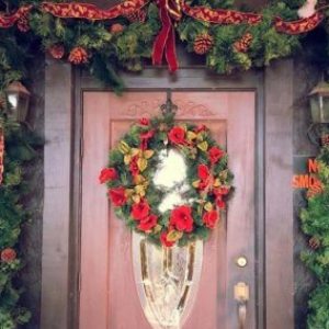 a vase of flowers is sitting on the side of a building