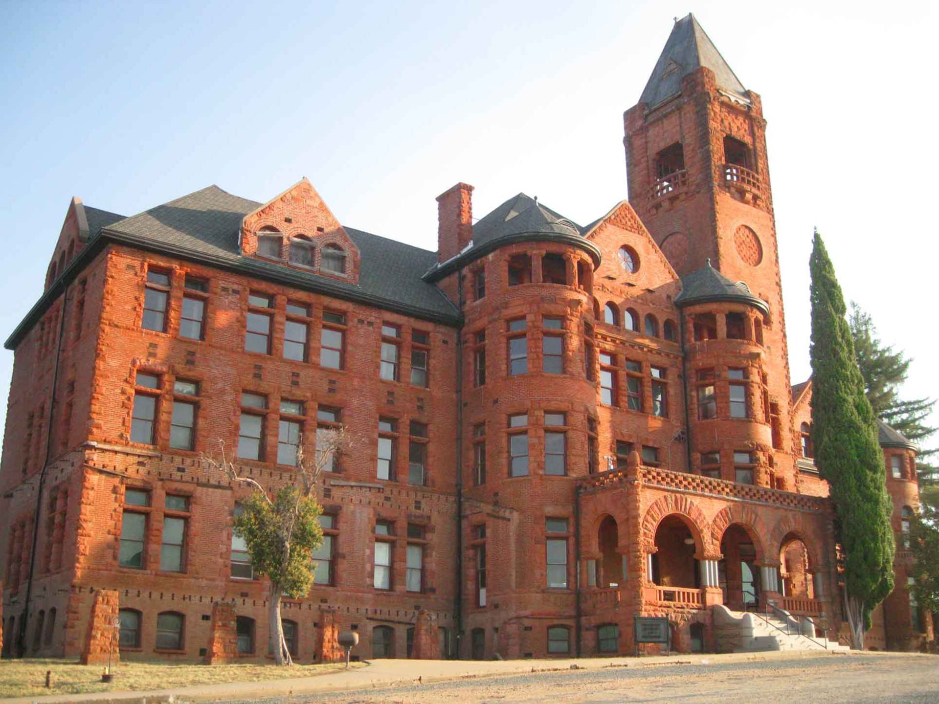 a large brick building with Preston School of Industry in the background