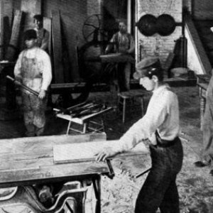 a group of people sitting around a wooden table
