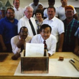 a group of people standing around a table