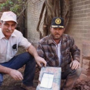 a man sitting in front of a building