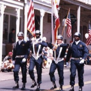 a group of people crossing a street in front of a crowd