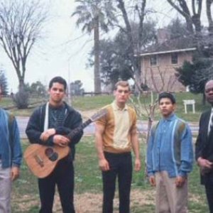 a group of people standing in a field