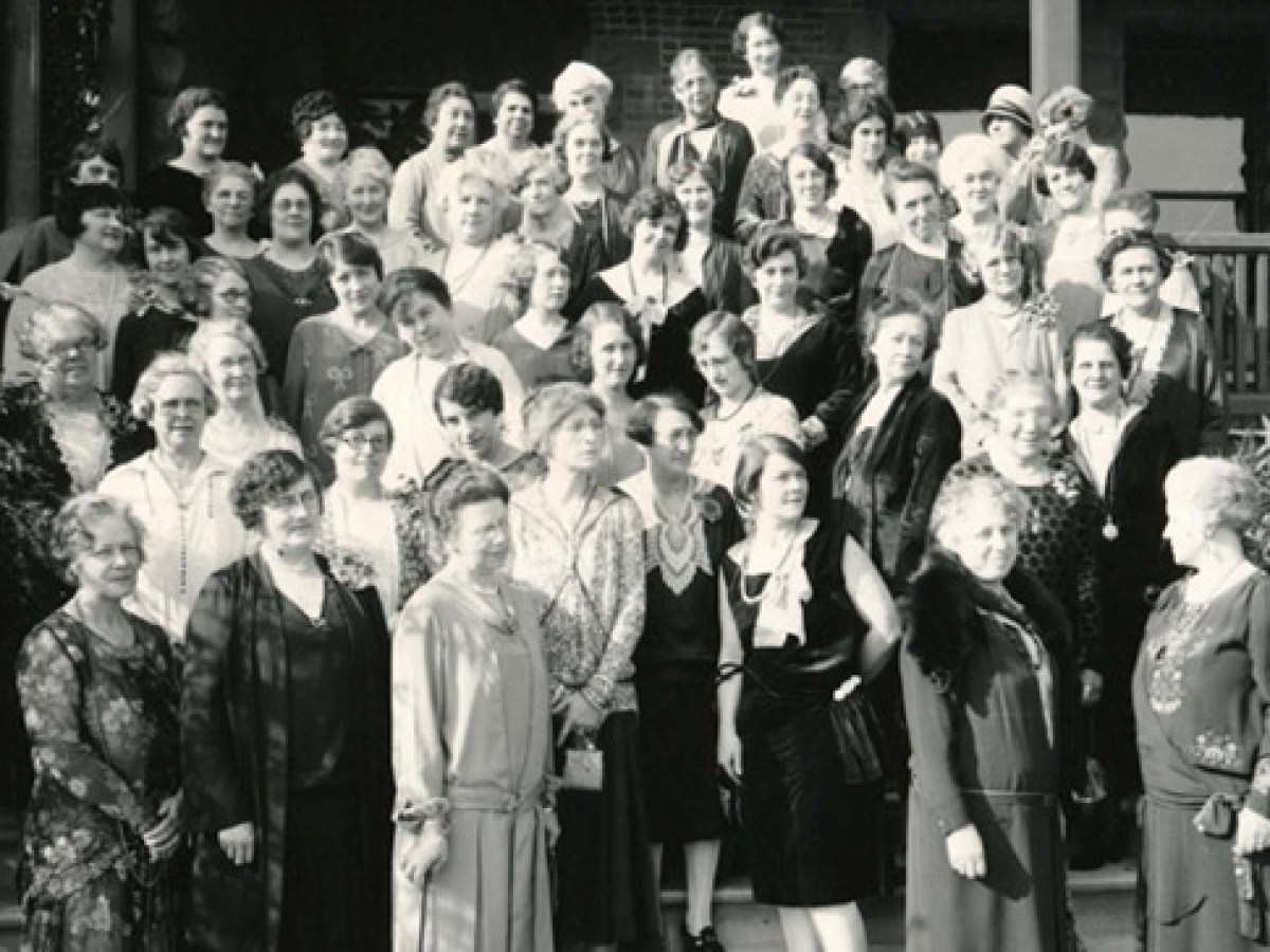 a group of people standing in front of a crowd posing for the camera