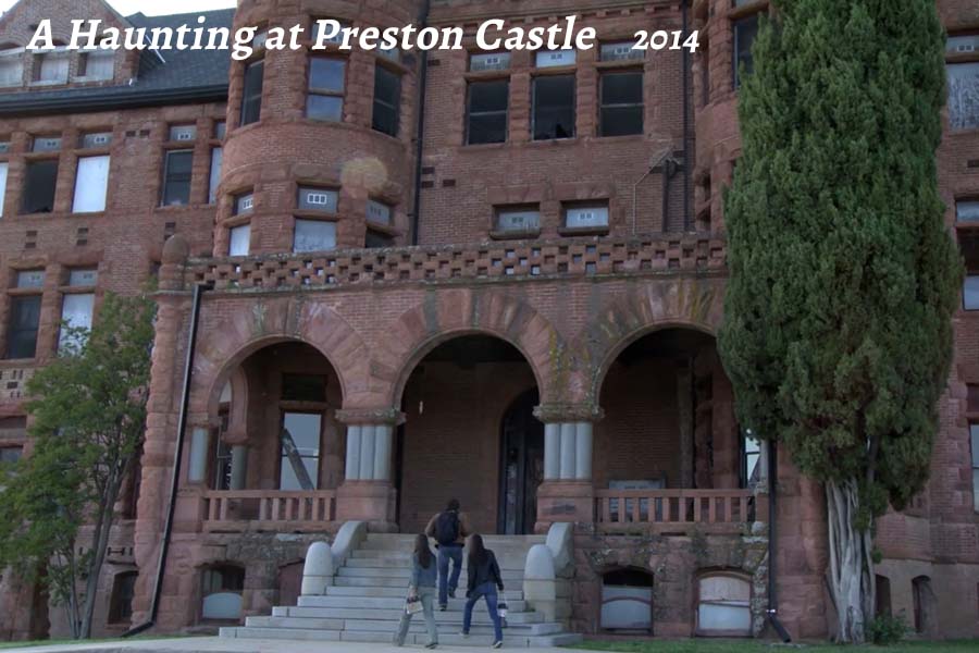 a large stone statue in front of a brick building