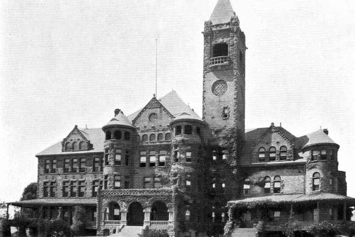 a vintage photo of a clock tower in front of a building