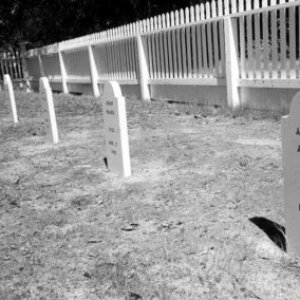 a sign in front of a fence