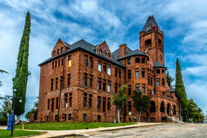 a castle with a clock tower in front of Preston School of Industry