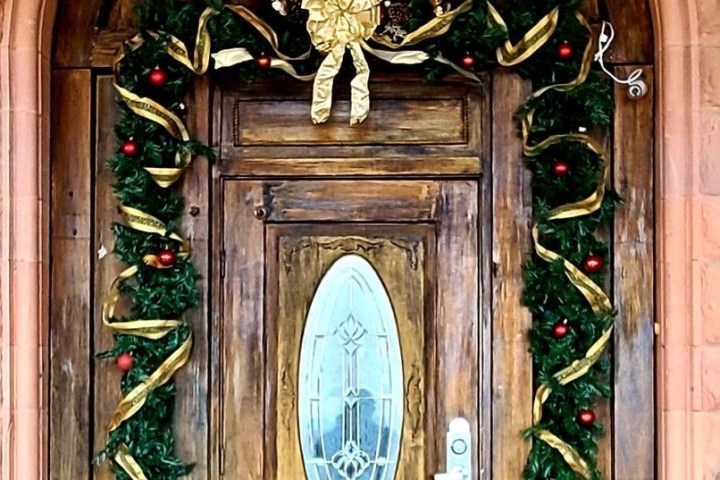 a large brick building with a clock on top of a wooden door