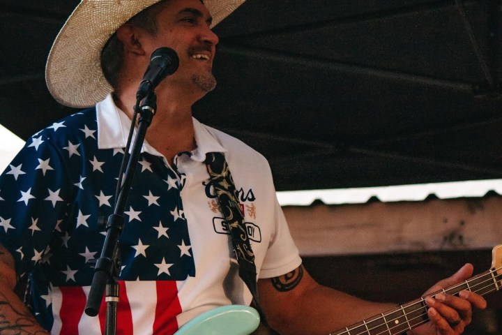 a man wearing a hat and holding an umbrella