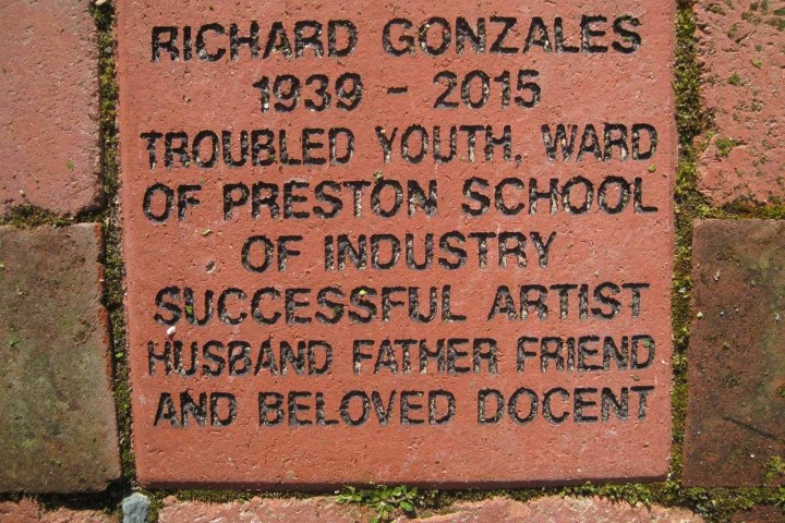 Memorial brick for Richard Gonzales, 1939-2015, noting achievements and personal roles.